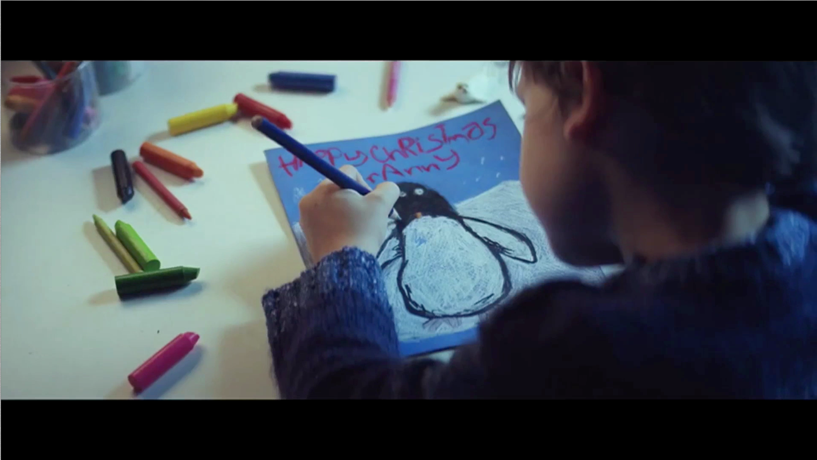 The main character of the advert draws Monty the Penguin