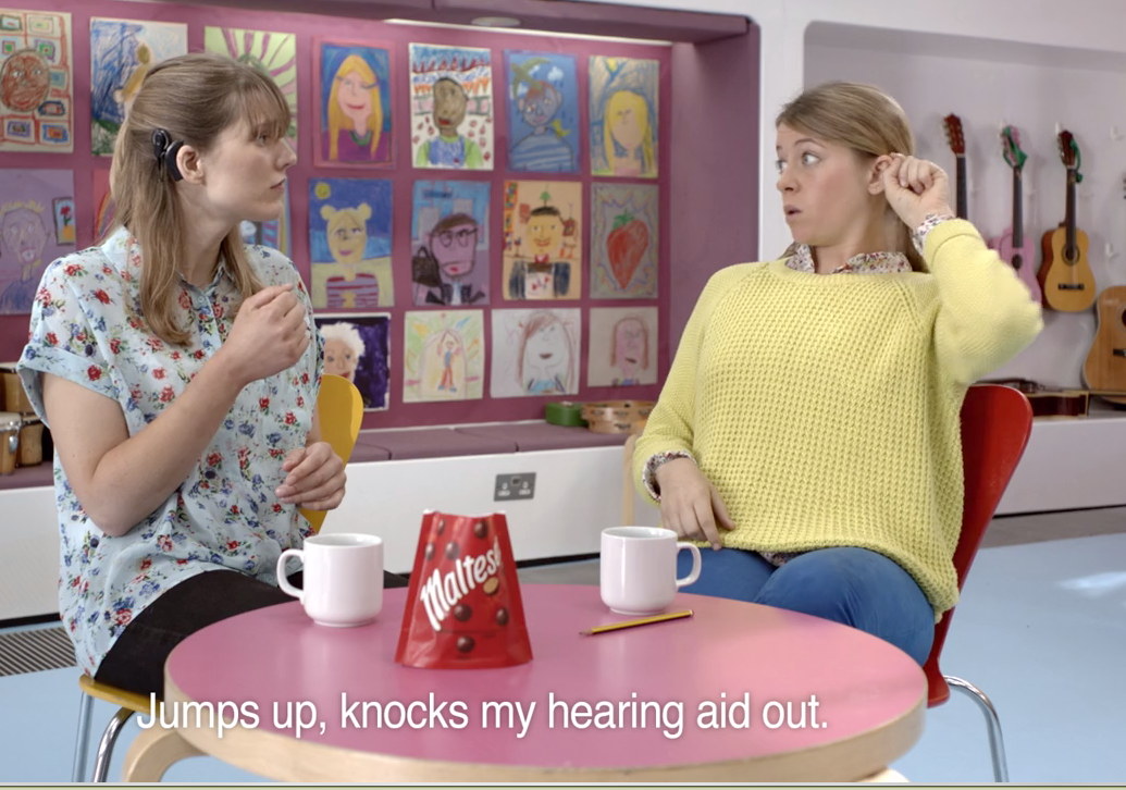 A still of one of the adverts, showing the advert conducted in sign language. 